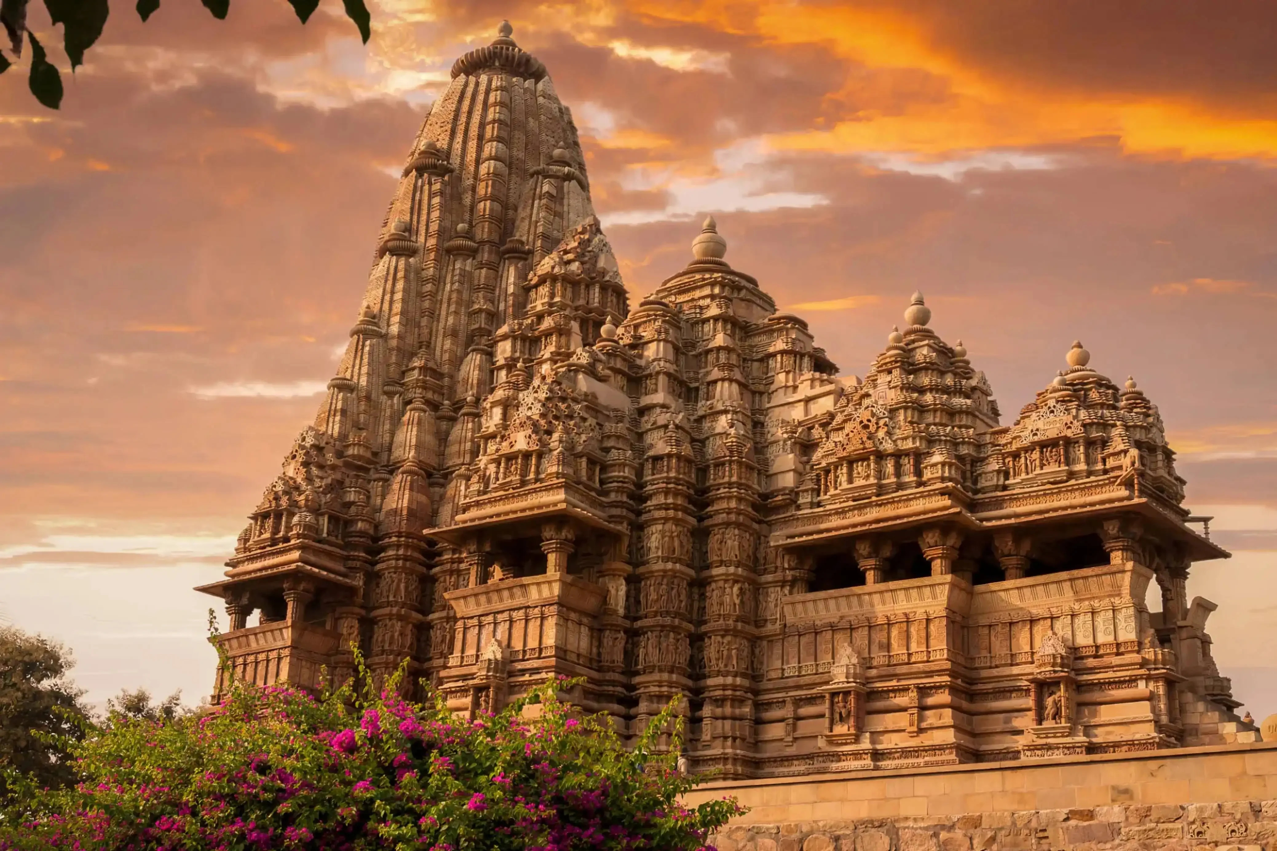 "Khajuraho temple in India at sunset with intricate ancient architecture"