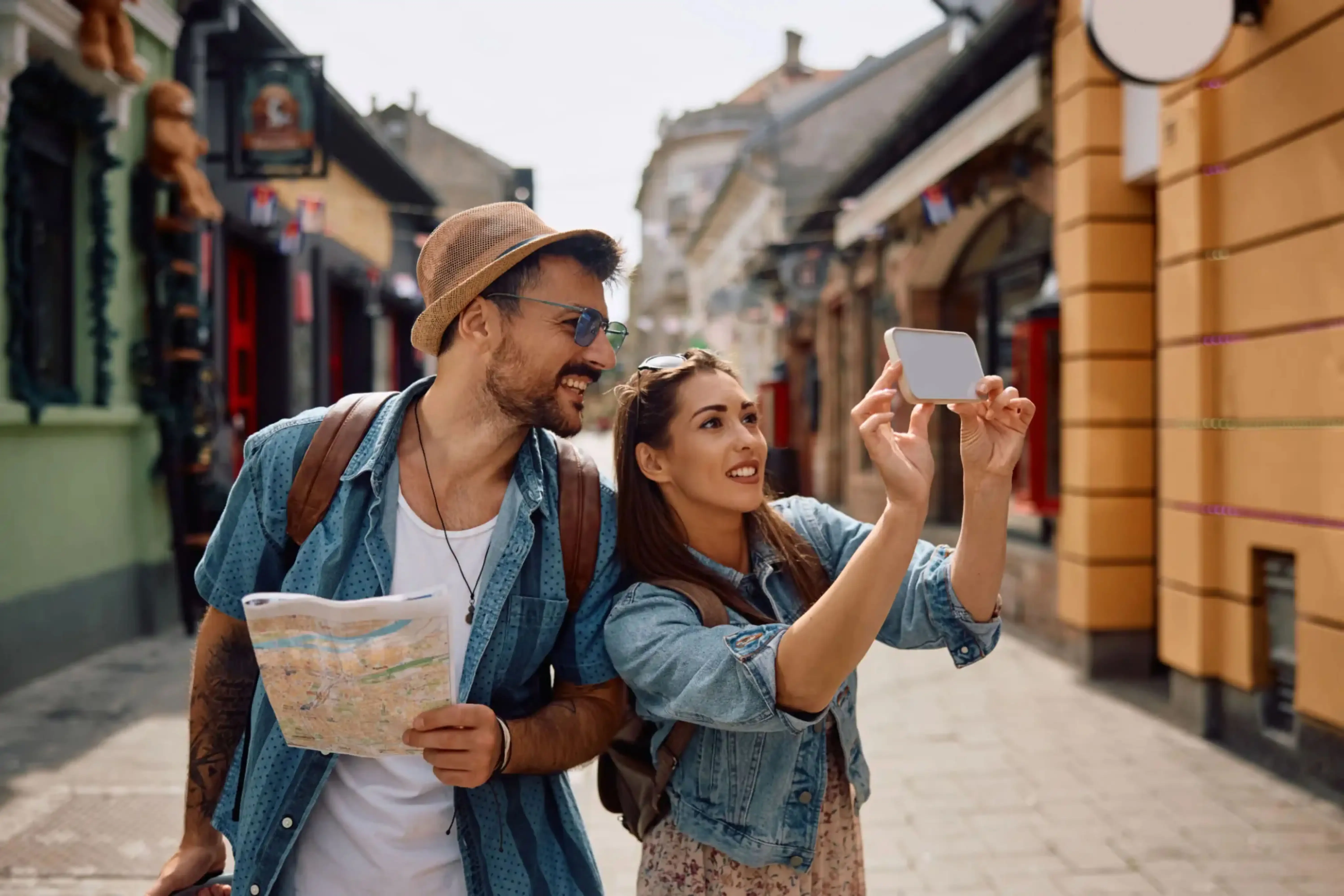 "Couple sightseeing in European city with map and smartphone"