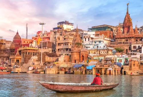 "Boat on Ganges River with view of historic ghats in Varanasi, India"