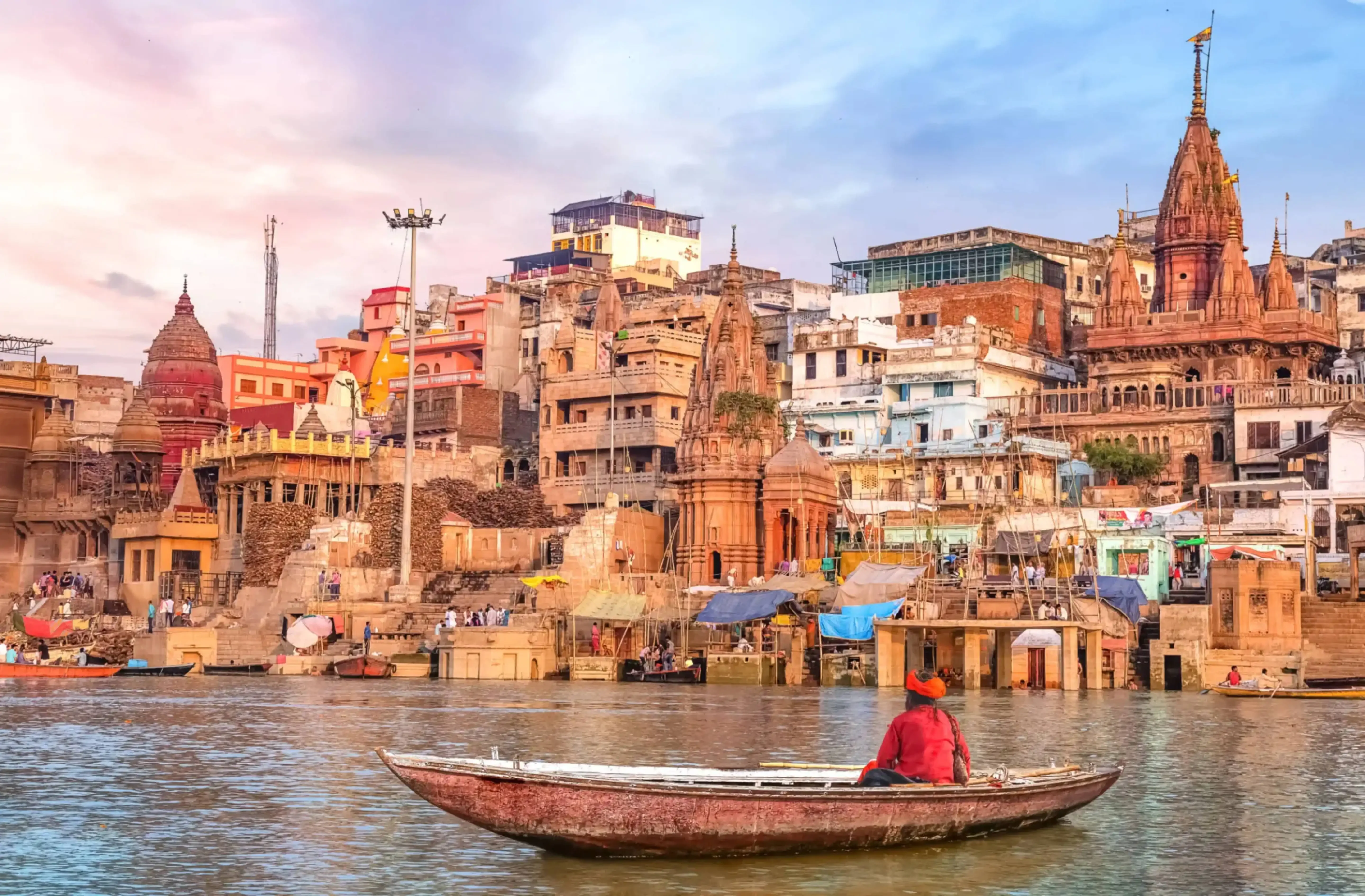 "Boat on Ganges River with view of historic ghats in Varanasi, India"