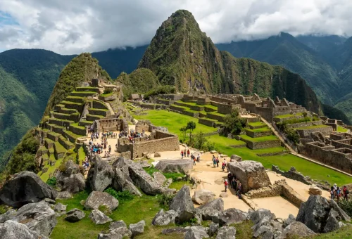 "Panoramic view of Machu Picchu ruins in Peru with surrounding Andean mountains"