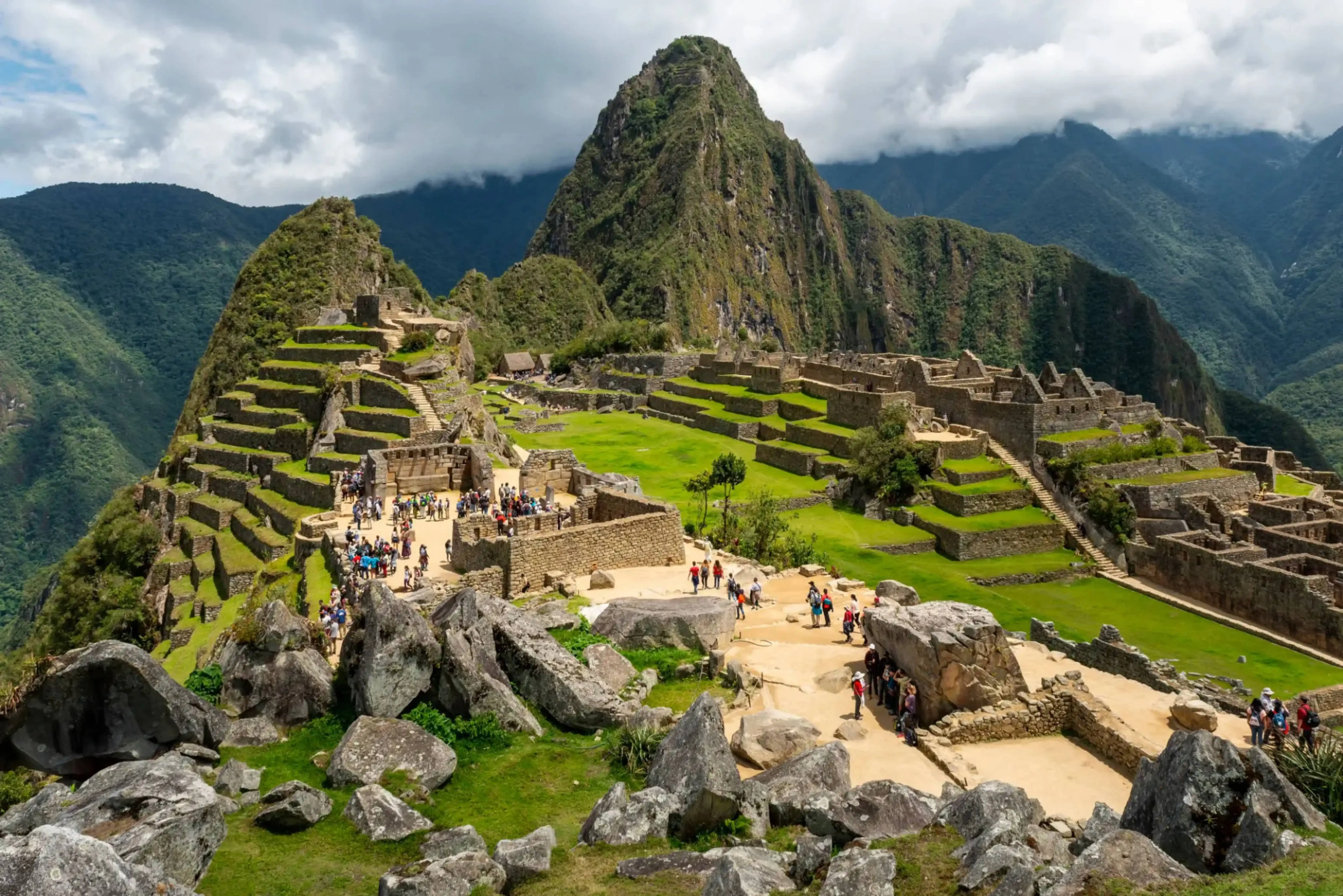 "Panoramic view of Machu Picchu ruins in Peru with surrounding Andean mountains"