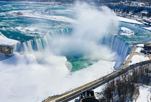 "Aerial view of Niagara Falls in winter with snow and mist, Canada"