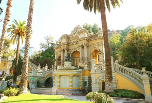 "Neptune Fountain and grand staircase at Cerro Santa Lucía park in Santiago, Chile, surrounded by palm trees and lush greenery."