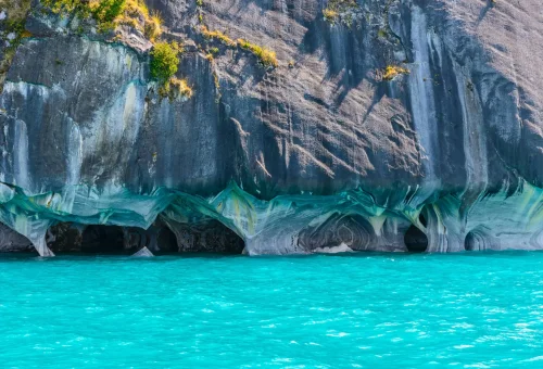 "Marble Caves of General Carrera Lake in Patagonia, Chile, with turquoise waters reflecting the swirling blue and gray cave walls."
