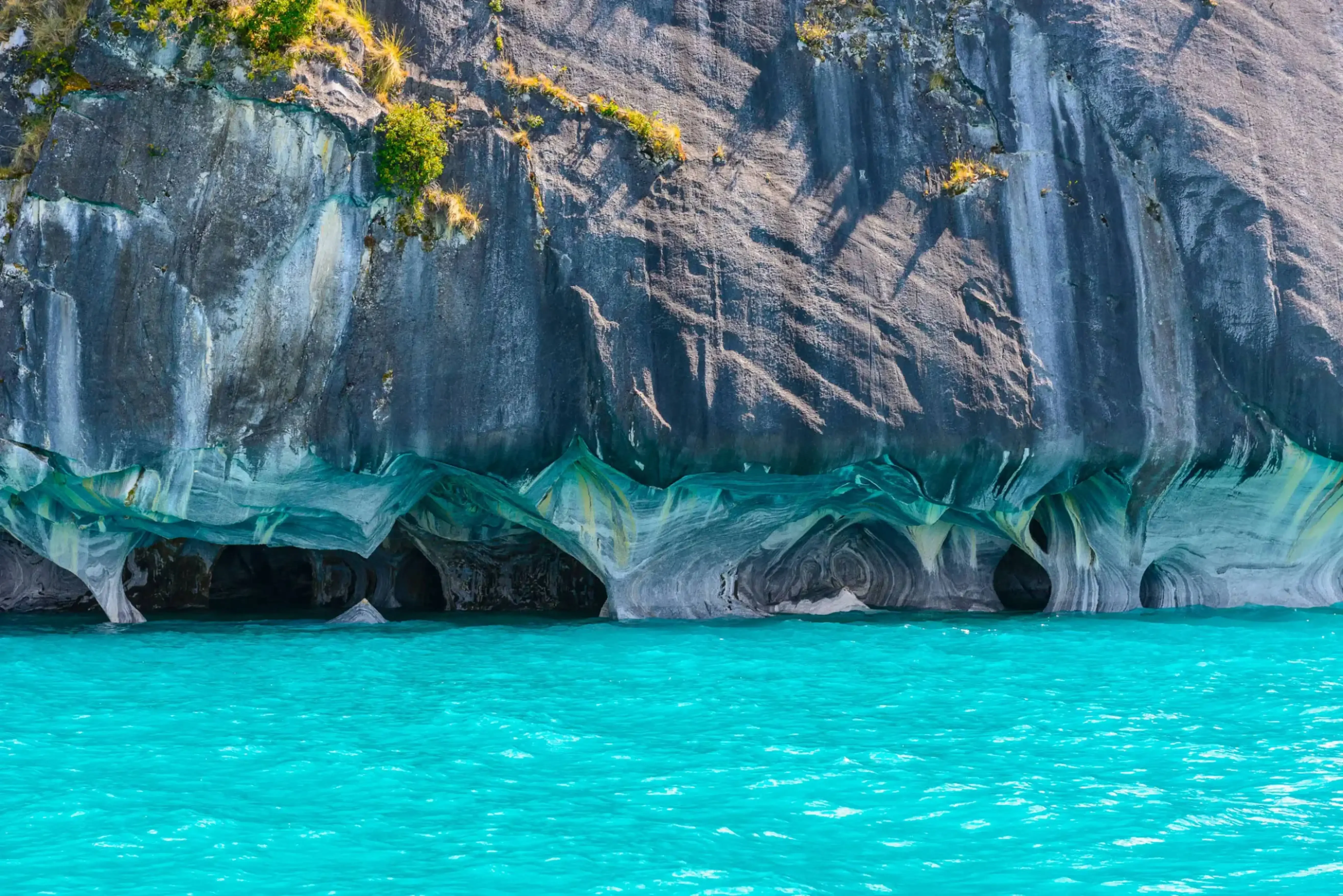 "Marble Caves of General Carrera Lake in Patagonia, Chile, with turquoise waters reflecting the swirling blue and gray cave walls."