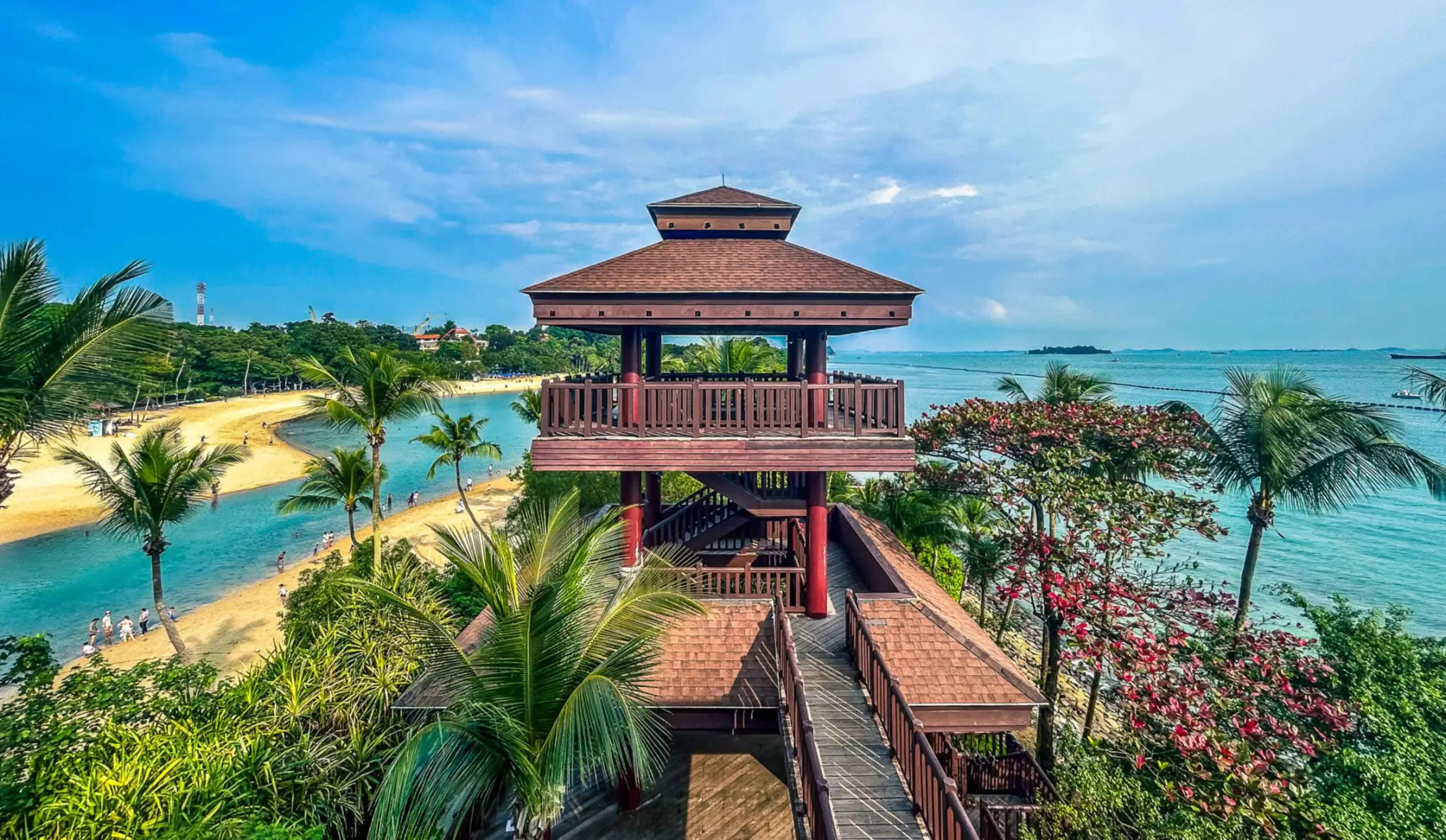 Wooden viewing pavilion overlooking the beach and lush tropical surroundings on Sentosa Island, Singapore.