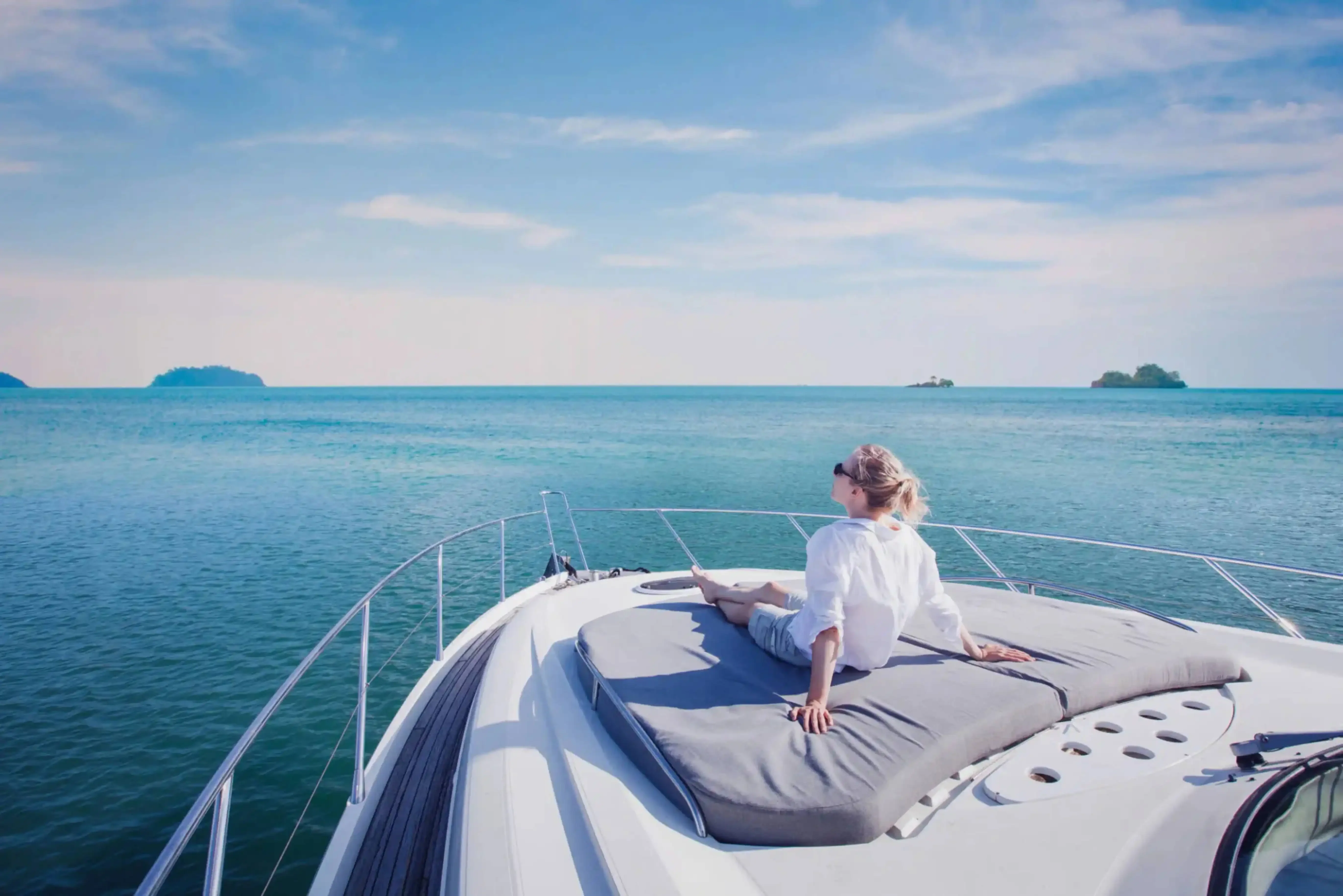 Woman relaxing on a luxury yacht deck with panoramic ocean views