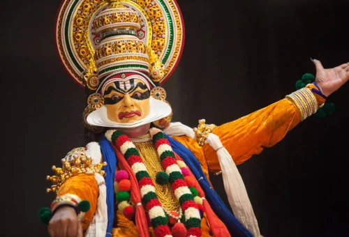 Traditional Kathakali dancer in full costume and elaborate makeup performing in Kerala, India