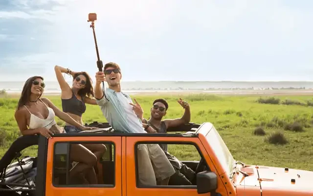 Happy-group-of-friends-taking-selfie-during-road-trip