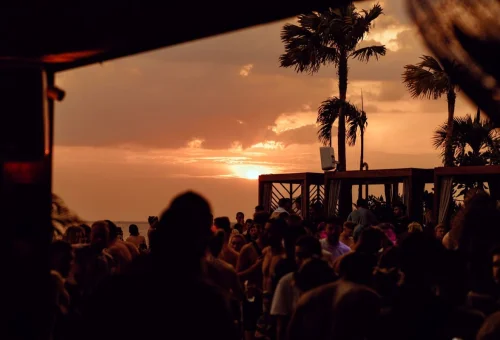 Sunset party atmosphere at Yona Beach Club Phuket with tropical drinks