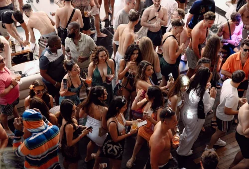 Floating pool party at Yona Beach Club Phuket with tourists and cocktails