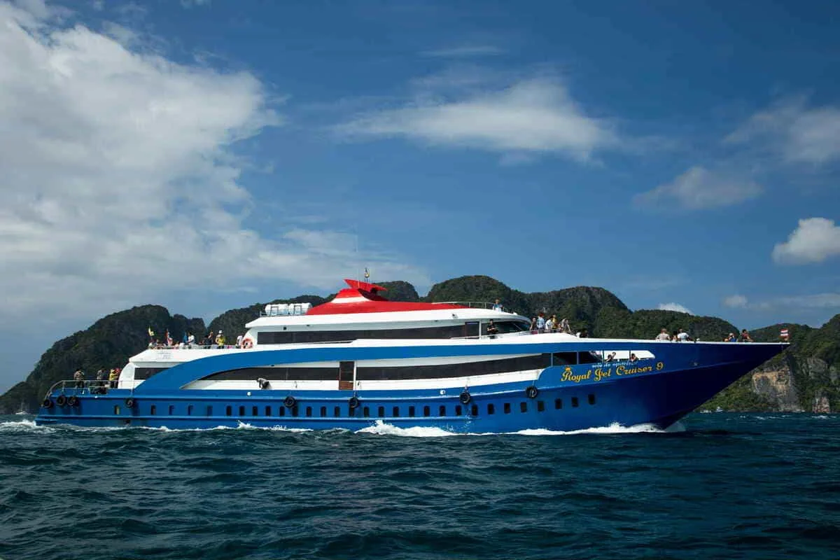 Phuket to Phi Phi Islands ferry boat cruising on turquoise sea with passengers