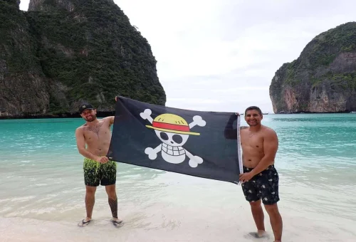 Pirate boat adventure Phi Phi Islands limestone cliffs ocean Thailand