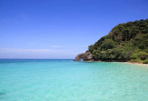 Traditional Thai longtail boat taking visitors into Maya Bay.