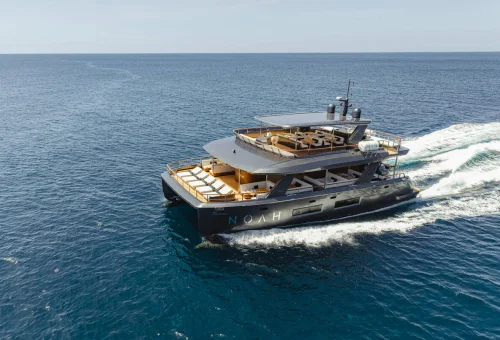 Aerial view of a luxury catamaran cruising through the Andaman Sea near Phi Phi Islands.