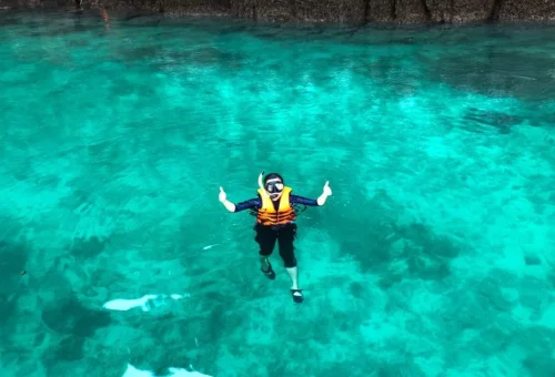 Private speedboat exploring a turquoise lagoon surrounded by limestone cliffs