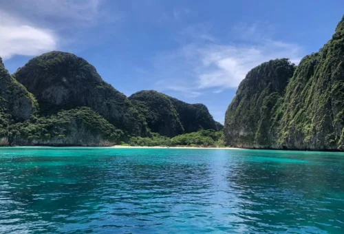 Turquoise water and limestone cliffs seen from a private speedboat near Phi Phi Islands