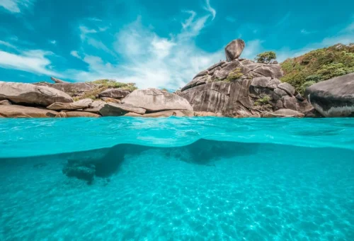 Turquoise sea and granite coastline during a Similan Islands tour from Phuket