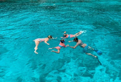 Family snorkeling in Similan Islands turquoise waters on a private tour
