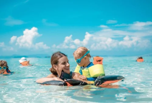 Children swimming in shallow water at Khai Islands Phuket