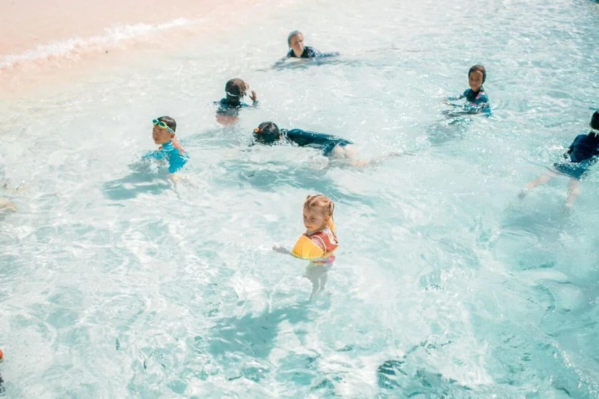 Children swimming in shallow water at Khai Islands near Phuket