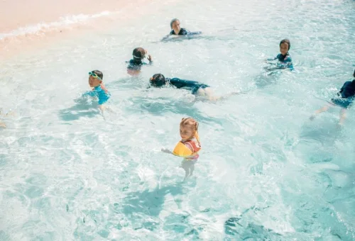 Children swimming in shallow water at Khai Islands near Phuket