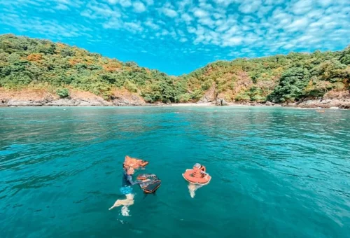 Family snorkeling at Coral Island Phuket on a private speedboat tour