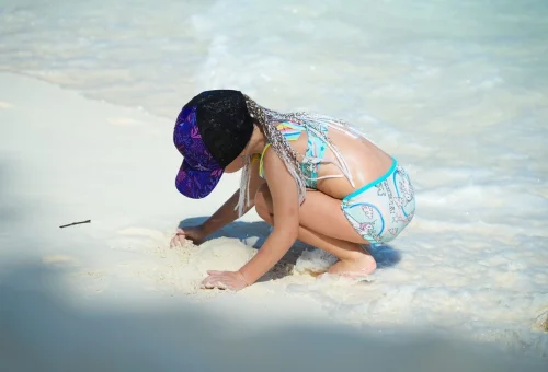 Child enjoying white sand beach at Similan Islands
