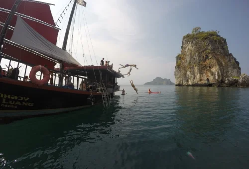 Guests jumping into the sea during the Krabi 4 Islands Sunset Cocktail Cruise