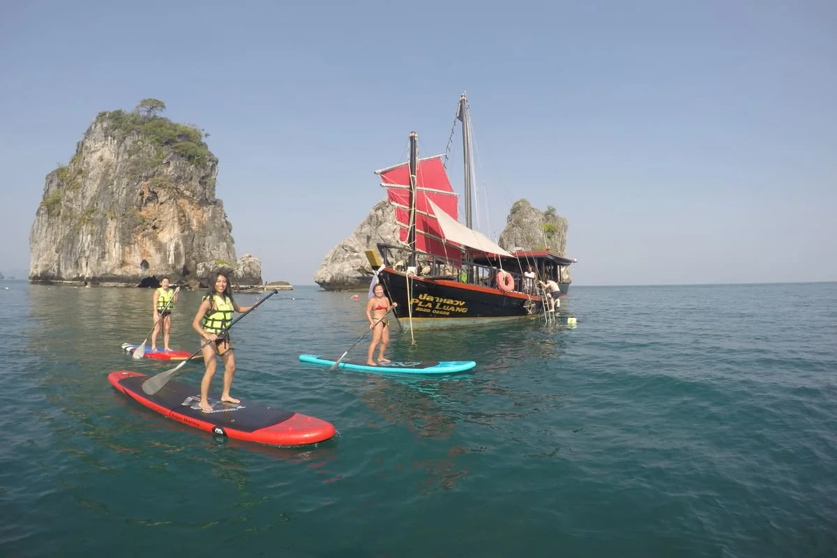 Guests stand-up paddleboarding during the Krabi 4 Islands Sunset Cocktail Cruise