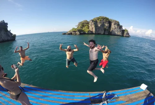 Guests jumping into the sea during the Krabi 4 Islands Sunset Cocktail Cruise