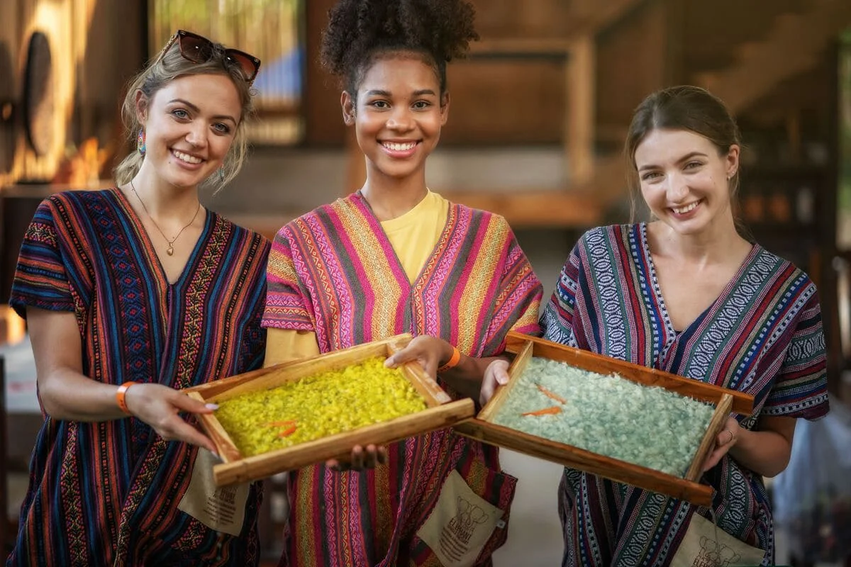 Visitors learning about sustainable elephant poop paper making in Chiang Mai