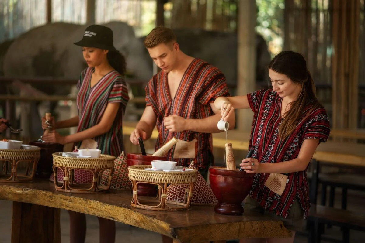 Visitors learning traditional Thai cooking during Chiang Mai Elephant Jungle Sanctuary One Day Care