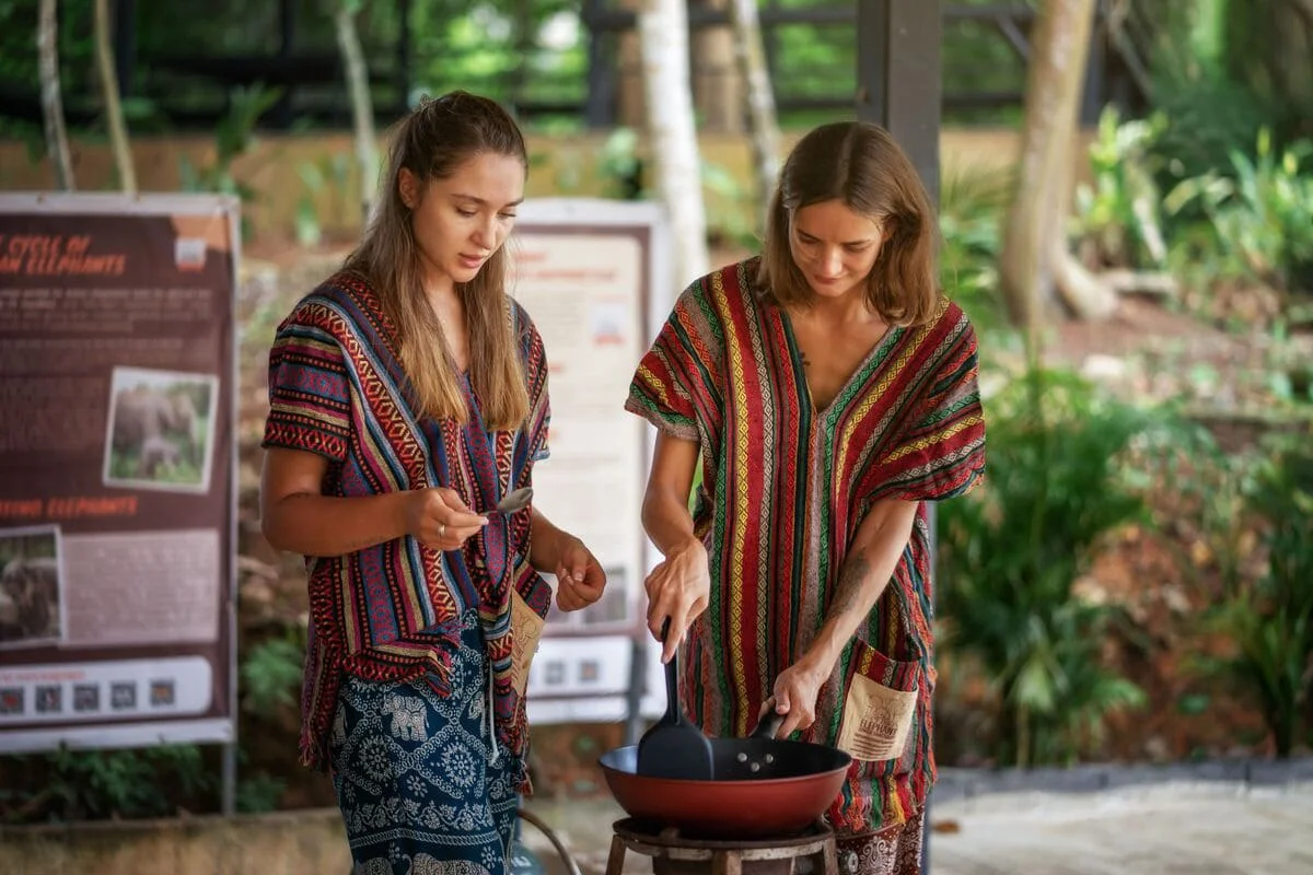 Guests enjoying a Thai cooking activity during the Phuket Elephant Jungle Sanctuary One Day Walk Experience