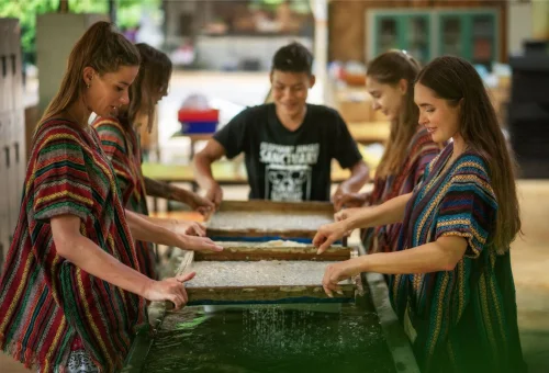Guests taking part in a traditional activity during the Phuket Elephant Jungle Sanctuary One Day Walk Experience