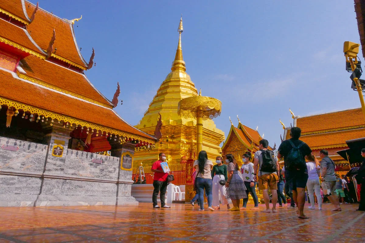 Visitors exploring the golden chedi at Doi Suthep Chiang Mai