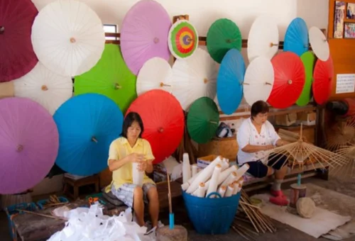 Artisans making traditional umbrellas at San Kamphaeng Chiang Mai