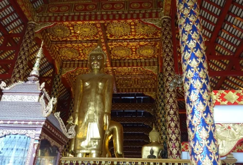 Golden Buddha statue inside a traditional Chiang Mai temple