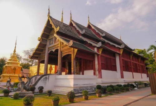 Historic Chiang Mai temple with golden stupa and traditional architecture