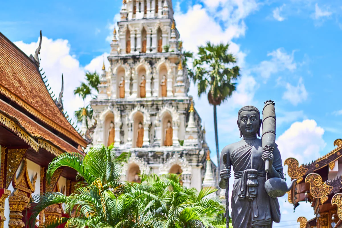 Buddha statue and traditional temple architecture in Lamphun Thailand