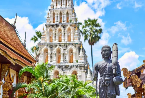 Buddha statue and traditional temple architecture in Lamphun Thailand