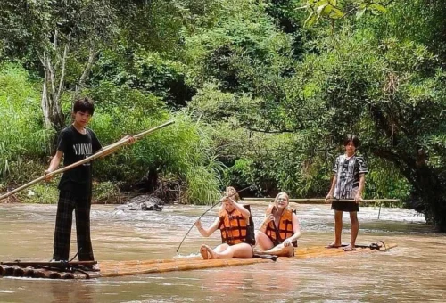 Visitors enjoying bamboo rafting on the Mae Wang River