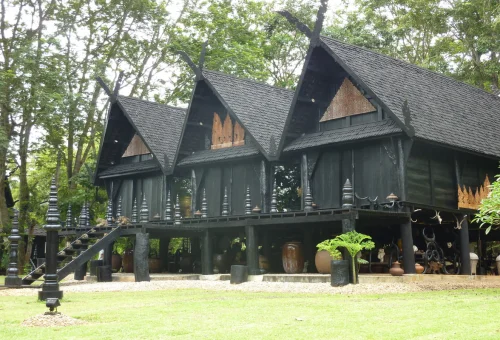 Traditional black wooden buildings at Baan Dam Museum Chiang Rai