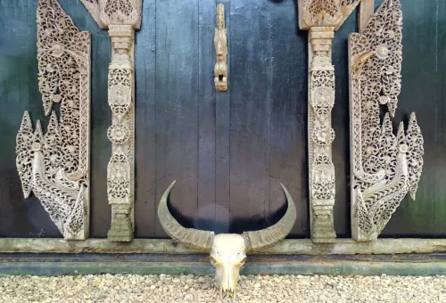 Buffalo skull and traditional artwork at Black House Chiang Rai