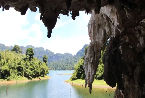 Cheow Lan Lake and limestone cliffs viewed from inside a cave in Khao Sok National Park