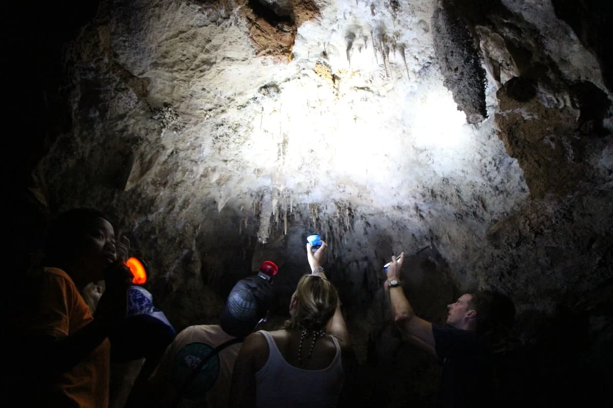 Visitors explore a limestone cave during the Khao Sok jungle and lake adventure