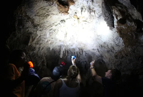 Visitors explore a limestone cave during the Khao Sok jungle and lake adventure