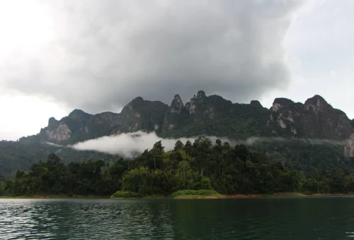 Dramatic limestone mountains rising above Cheow Lan Lake during a Khao Sok lake adventure