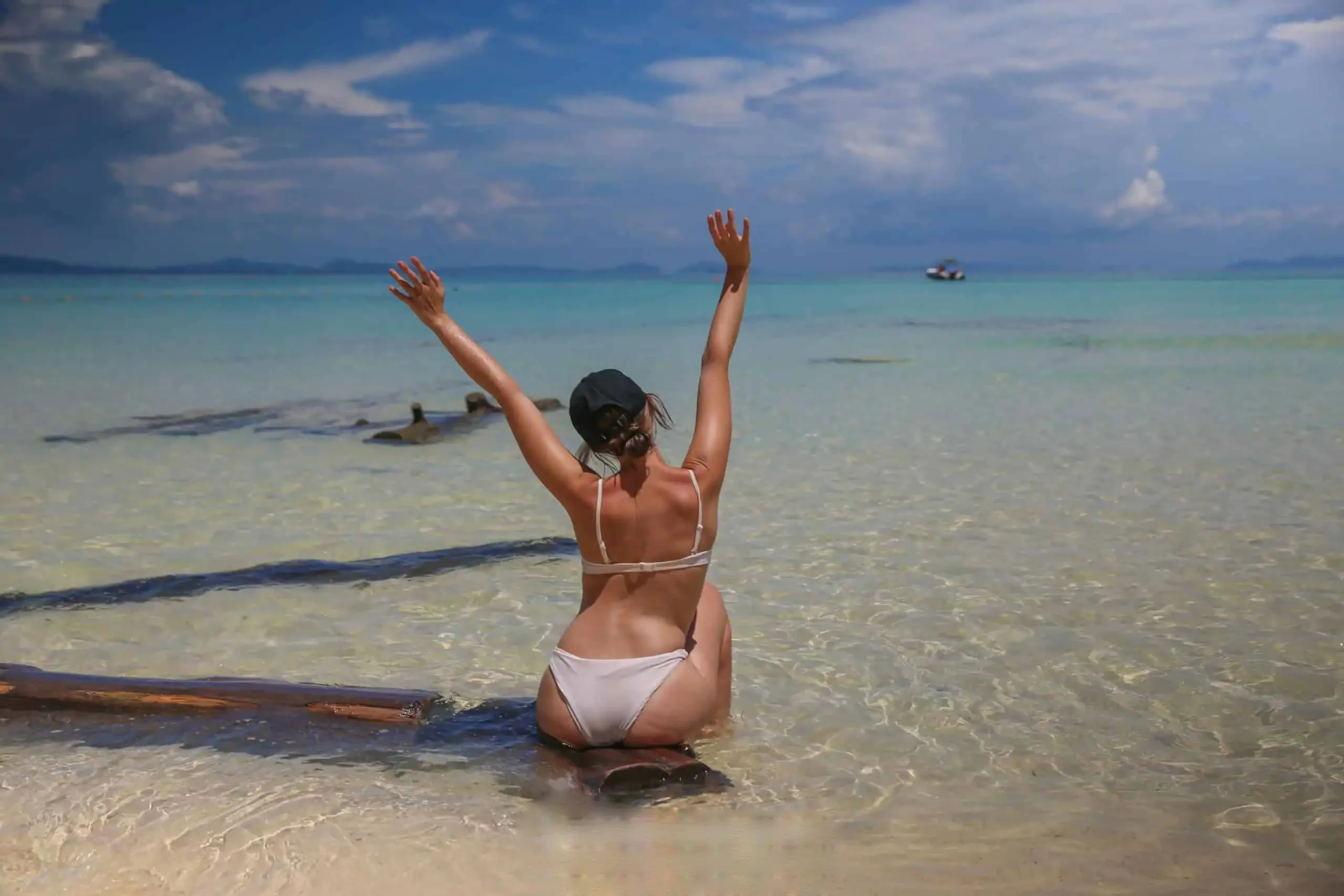 Guest sunbathing on a quiet, pristine beach at the Phi Phi Islands, surrounded by turquoise waters and tropical scenery during the X-Large Early Bird tour.